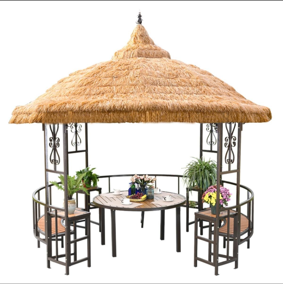 Yurt-style thatched gazebo with table and chairs